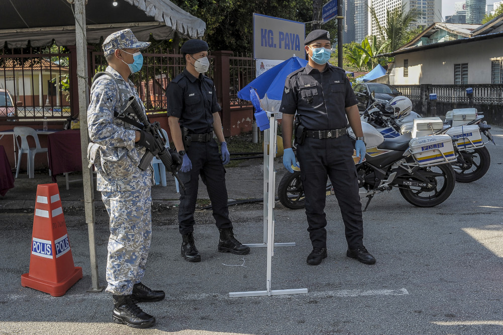 Army and police personnel conducting roadblocks during the movement control order (MCO) in Kuala Lumpur April 19, 2020. u00e2u20acu201d Picture by Shafwan Zaidon
