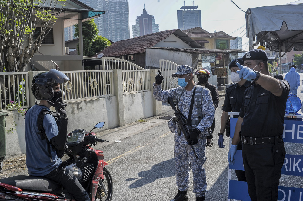 Army and police personnel conducting roadblocks during the movement control order (MCO) in Kuala Lumpur April 19, 2020. u00e2u20acu201d Picture by Shafwan Zaidon