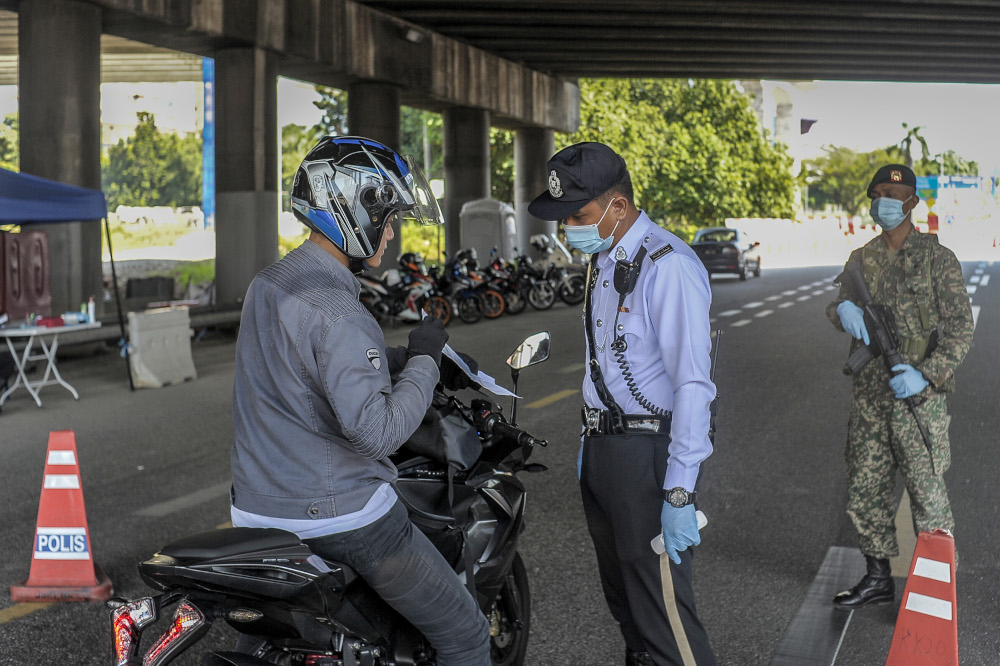 Army and police personnel conducting roadblocks during the movement control order (MCO) in Kuala Lumpur April 19, 2020. u00e2u20acu201d Picture by Shafwan Zaidon
