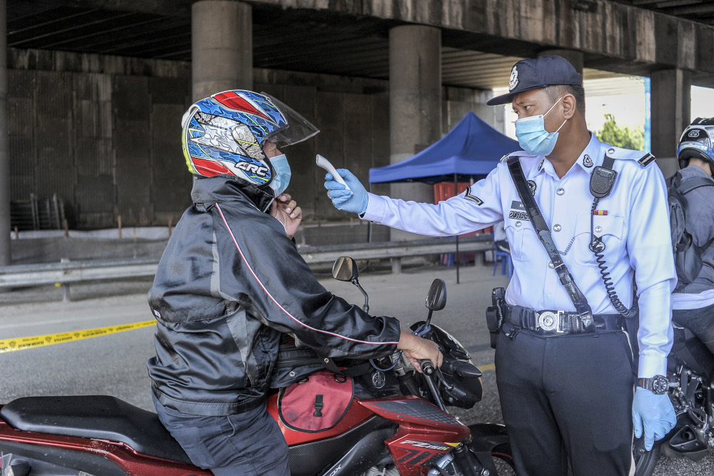 Army and police personnel conducting roadblocks during the movement control order (MCO) in Kuala Lumpur April 19, 2020. u00e2u20acu201d Picture by Shafwan Zaidon