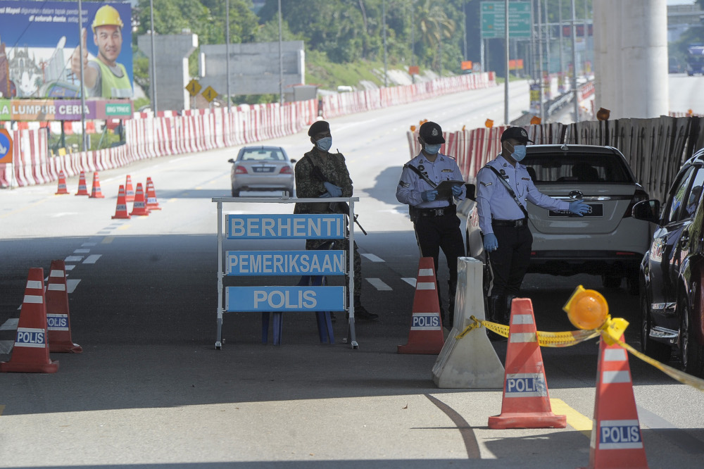 Army and police personnel conducting roadblocks during the movement control order (MCO) in Kuala Lumpur April 19, 2020. u00e2u20acu201d Picture by Shafwan Zaidon