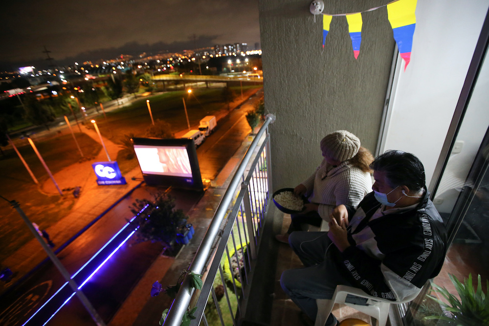 People watch a movie being shown on the street, from the balcony of their apartment, amid the outbreak of the coronavirus disease (Covid-19) in Bogota, Colombia April 22, 2020. u00e2u20acu201d Reuters pic