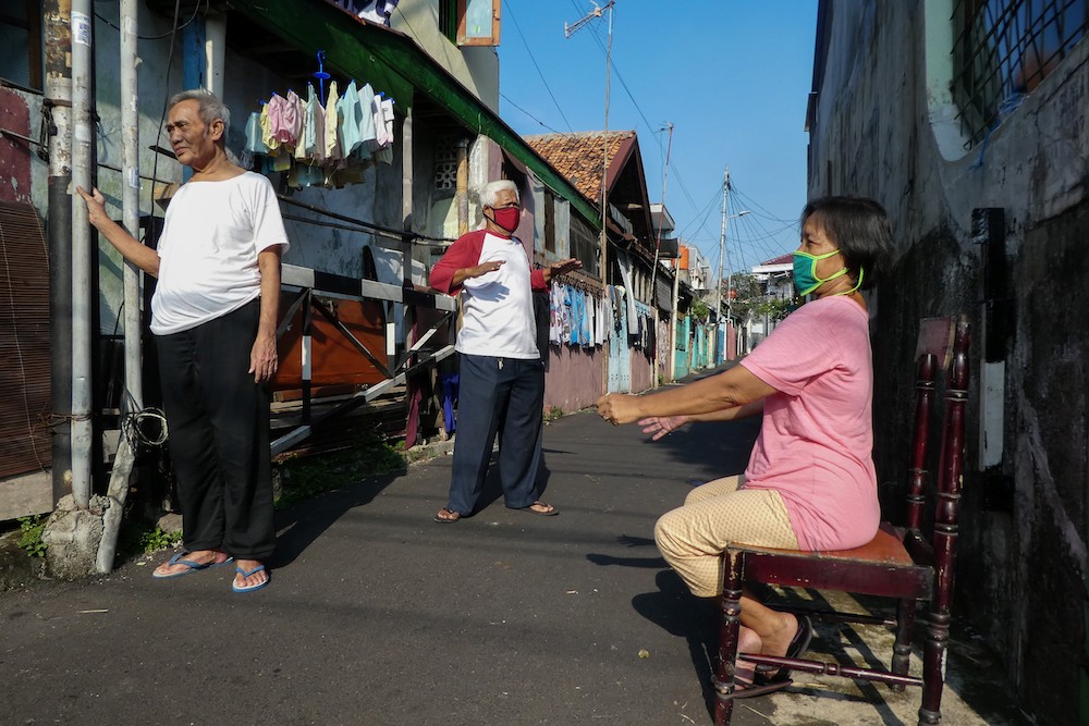 This file photo taken on April 17, 2020 shows people soaking up some sun in Jakarta with the belief that the sun can boost their body immunity. u00e2u20acu201d AFP pic