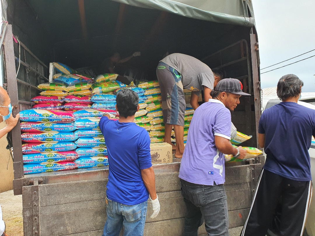 Workers unload bags of rice to be distributed to several households in Beserah following their loss of income when the movement control order took effect. u00e2u20acu2022 Picture courtesy of Aiman Azahari