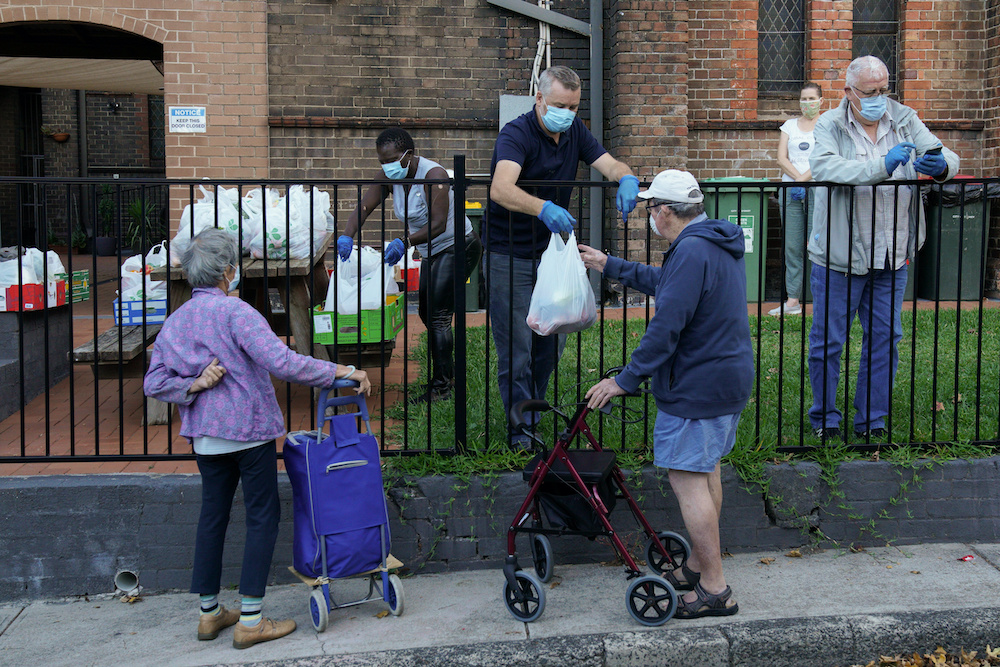 Pastor Matt Johnson of One1Seven evangelical Anglican church and his volunteers distribute food to those in need, an approved essential service during the spread of the coronavirus disease, in Sydney, Australia, April 17, 2020. —  Reuters pic