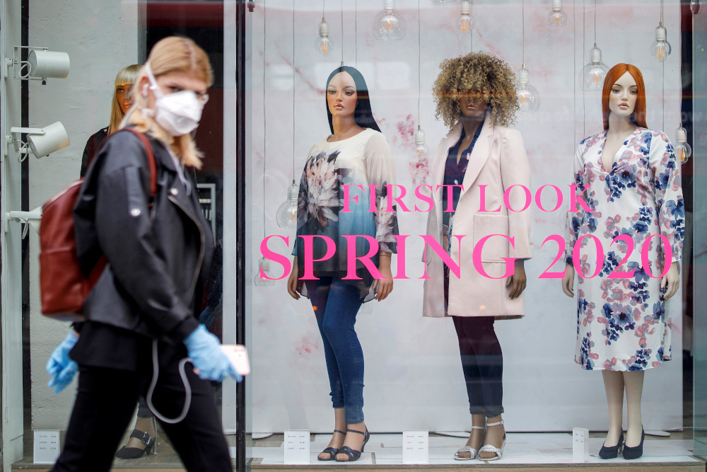 A woman wearing PPE (personal protective equipment), of a face mask as a precautionary measure against Covid-19, walks past an Evans clothing store, closed-down due to coronavirus, on Oxford Street in central London April 27, 2020. u00e2u20acu201d AFP pic