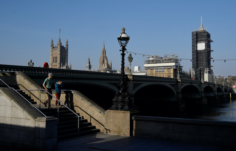 People take a walk near the Houses of Parliament as the spread of the coronavirus disease (Covid-19) continues, London, Britain, April 10, 2020. u00e2u20acu2022 Reuters  picnn