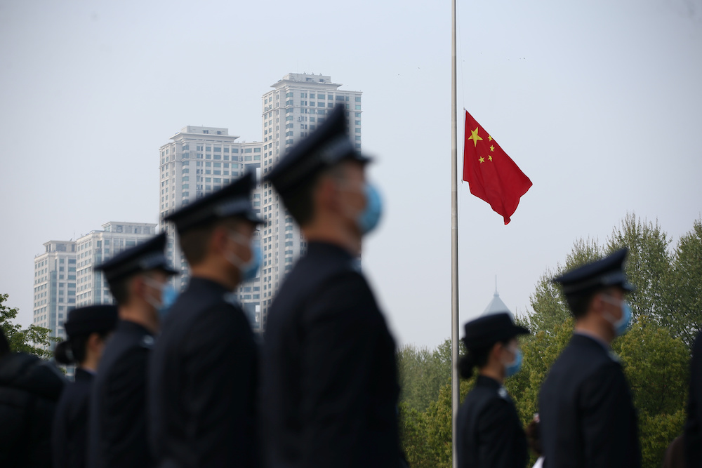 The Chinese national flag flies at half mast at a ceremony mourning those who died of the coronavirus disease (Covid-19) as China holds a nationwide mourning on the Qingming tomb-sweeping festival, in Wuhan, Hubei province, China April 4, 2020. u00e2u20acu201d Reuter