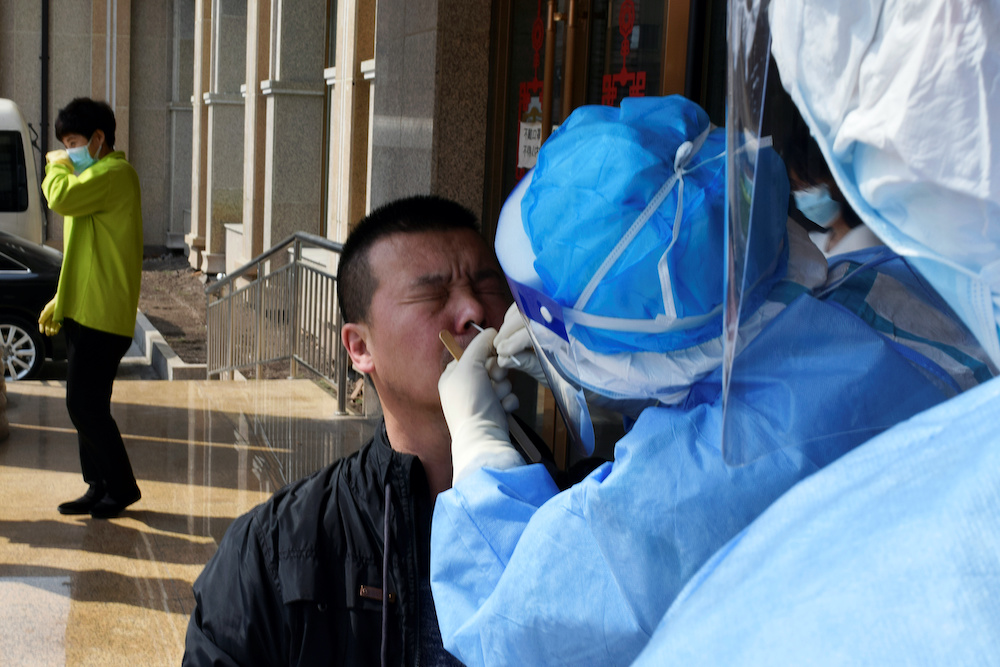 A worker from the cityu00e2u20acu2122s centre for disease control and prevention takes a swab from a man to test for the coronavirus disease (Covid-19) in Suifenhe, a city bordering Russia in Chinau00e2u20acu2122s Heilongjiang province, April 16, 2020. u00e2u20acu2022 Reuters pic