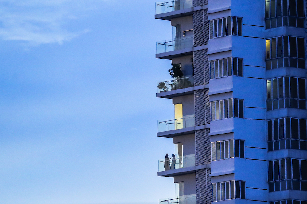 A man is seen at balcony of his apartment in Kuala Lumpur as people continue to adhere to the MCO, April 4, 2020. u00e2u20acu201d Picture by Firdaus Latif