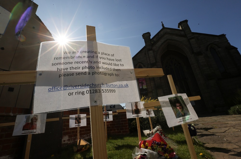Pictures and names of people who died during the lockdown, hang on crosses in a remembrance garden near a church, during the coronavirus disease outbreak, in Burton, in Staffordshire, Britain April 24, 2020. u00e2u20acu2022 Reuters pic