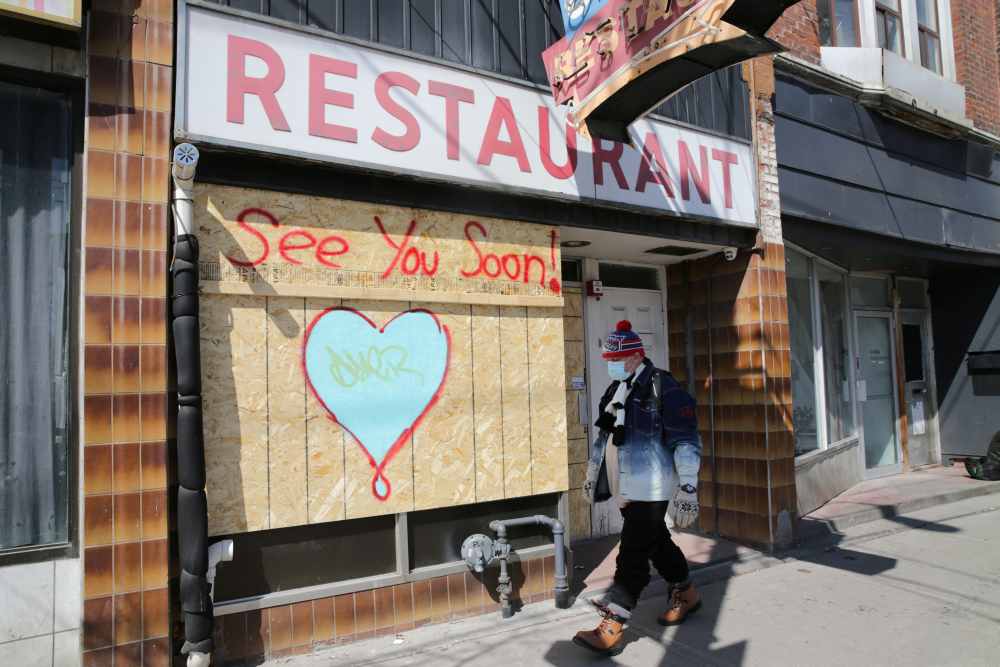 A man wearing a protective face mask passes a boarded up restaurant during the global outbreak of the coronavirus disease in Toronto, Ontario April 6, 2020. u00e2u20acu2022 Reuters pic