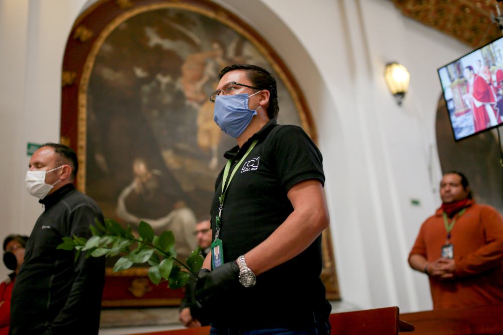 Camera assistants from a television channel wearing face masks attend a mass that is recorded and televised, inside the Primary Cathedral chapel, amid the Covid-19 outbreak in Bogota April 5, 2020. u00e2u20acu2022 Reuters pic