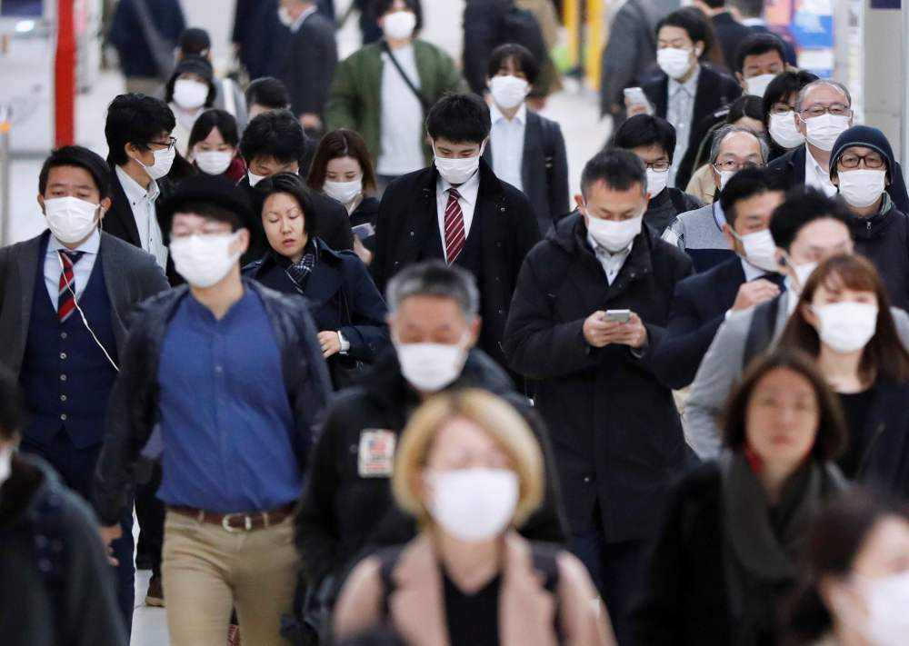 Passengers wearing protective face masks, following an outbreak of the Covid-19, walk to work the day before a state of emergency is expected to be imposed at a station in Tokyo April 7, 2020. u00e2u20acu2022 Reuters pic