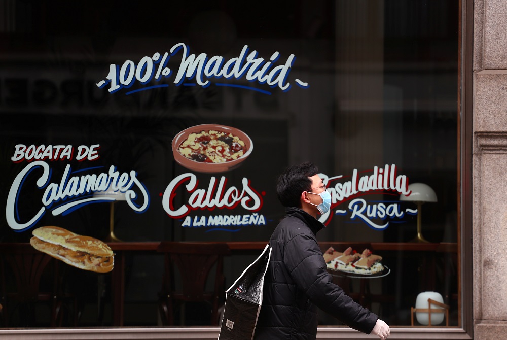 A man wearing a protective face mask walks past a closed restaurant amid the coronavirus disease outbreak in Madrid April 15, 2020. u00e2u20acu2022 Reuters pic