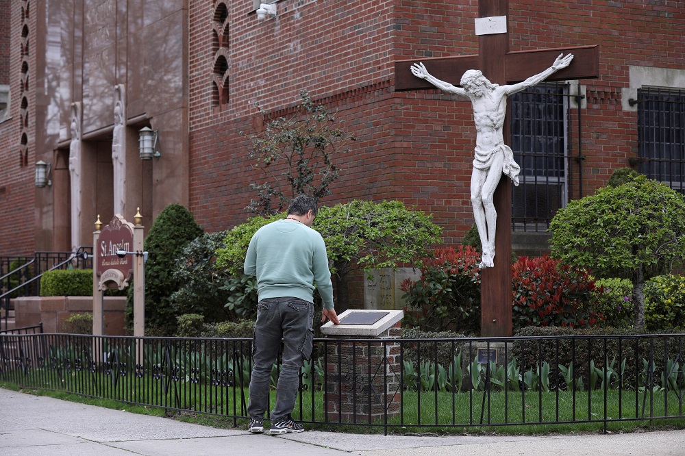 A man prays outside the closed Saint Anselm Church during the outbreak of coronavirus disease in the Brooklyn borough of New York April 10, 2020. u00e2u20acu2022 Reuters pic