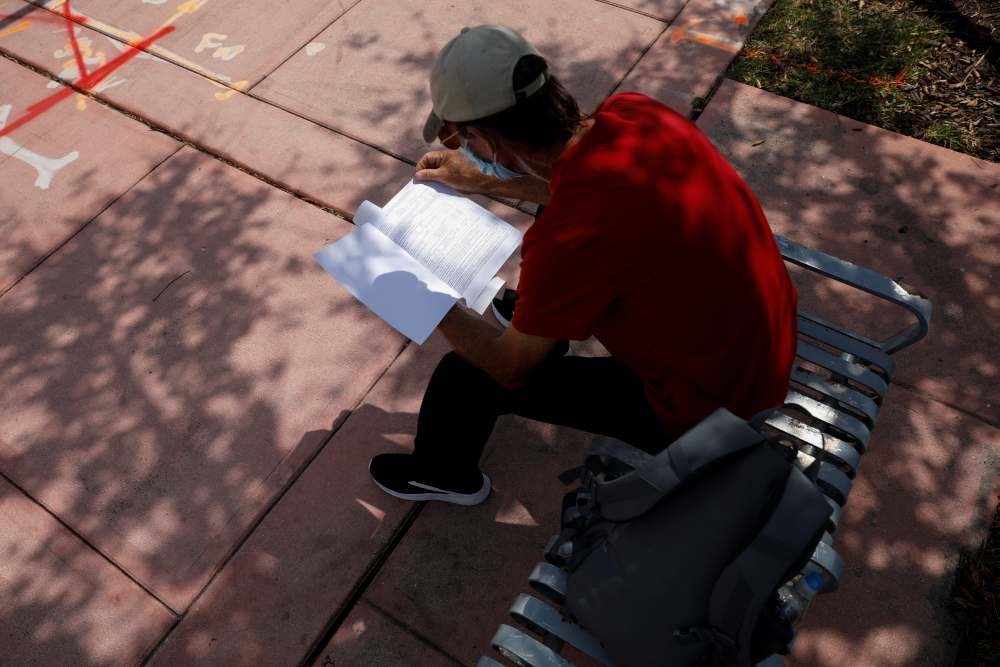 A man reads an unemployment form, as the outbreak of coronavirus disease continues, in Miami Beach, Florida April 8, 2020. u00e2u20acu2022 Reuters pic