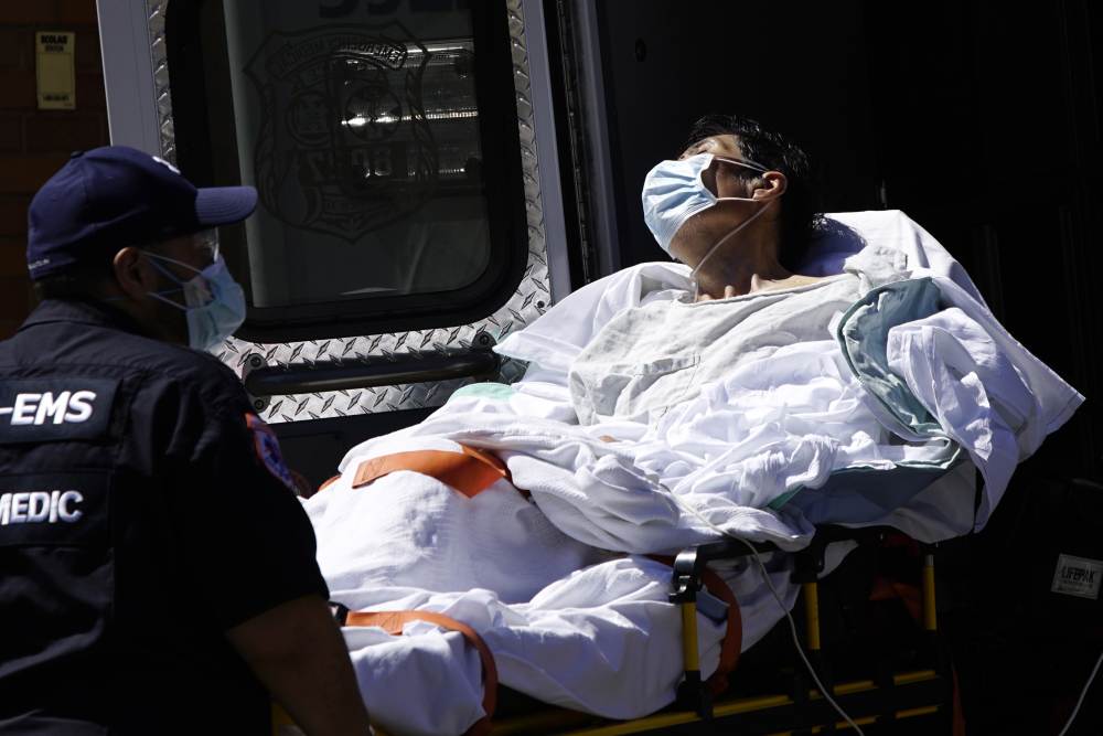 A paramedic takes a patient from an ambulance to an emergency arrival area at Elmhurst Hospital during the outbreak of the coronavirus disease in the Queens borough of New York April 6, 2020. u00e2u20acu2022 Reuters pic