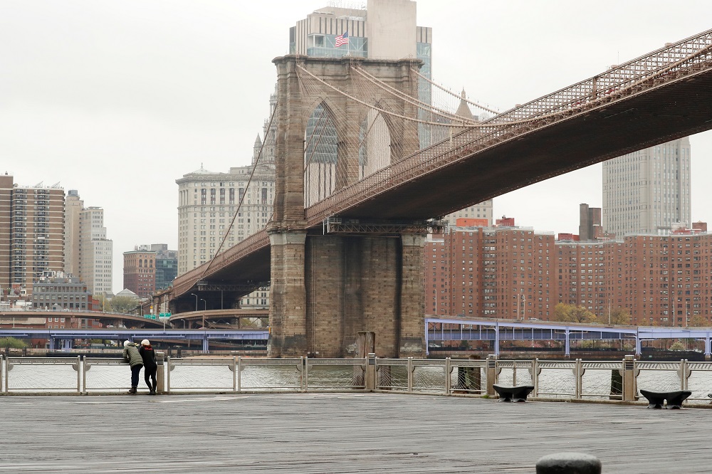 Pedestrians wearing masks look at the city skyline from Brooklyn Bridge Park as the spread of the coronavirus disease outbreak continues in the Brooklyn borough of New York City April 24, 2020. u00e2u20acu2022 Reuters pic
