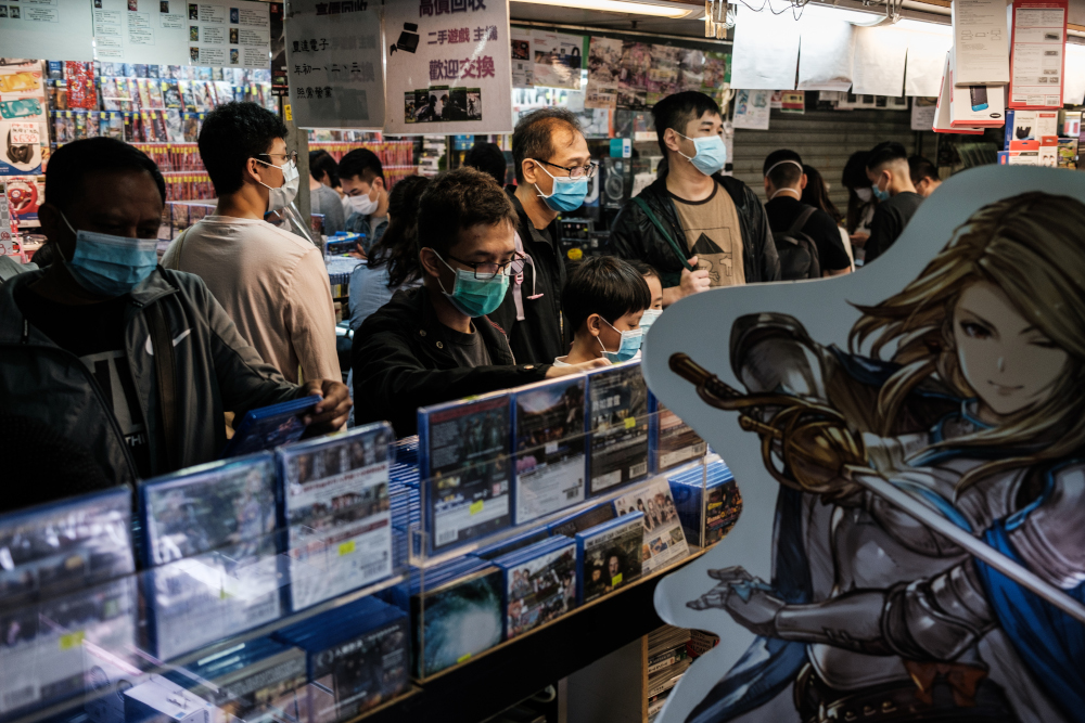 Customers browse computer games in a shopping mall as they wear face masks, as a precautionary measure against the Covid-19 coronavirus, in Hong Kong April 10, 2020. u00e2u20acu201d AFP pic 