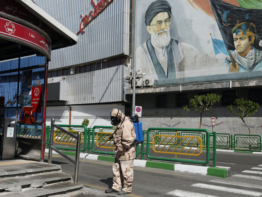 A volunteer from Basij forces wearing a protective suit and face mask sprays disinfectant as he sanitizes a bus station, amid the coronavirus disease (Covid- 19) fears, in Tehran, Iran April 3, 2020. u00e2u20acu201d Reuters picnnn