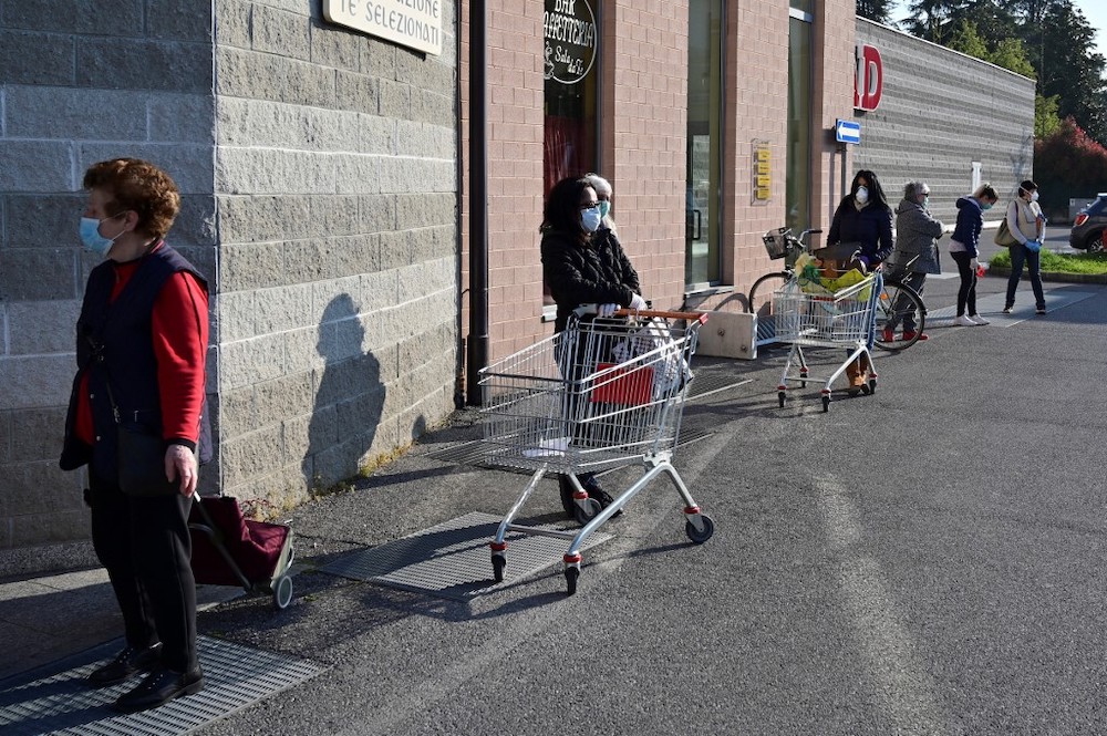 Women queue outside a supermaket on April 7, 2020 in Canonica du00e2u20acu2122Adda, in Lombardy. u00e2u20acu201d AFP pic