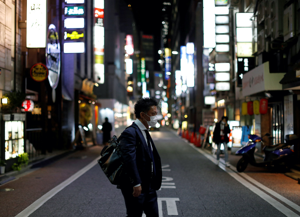 A man wearing a protective face mask, following an outbreak of the coronavirus disease (Covid-19), walks at Ginza shopping and amusement district in Tokyo, Japan April 2, 2020. u00e2u20acu201d Reuters picnnnn