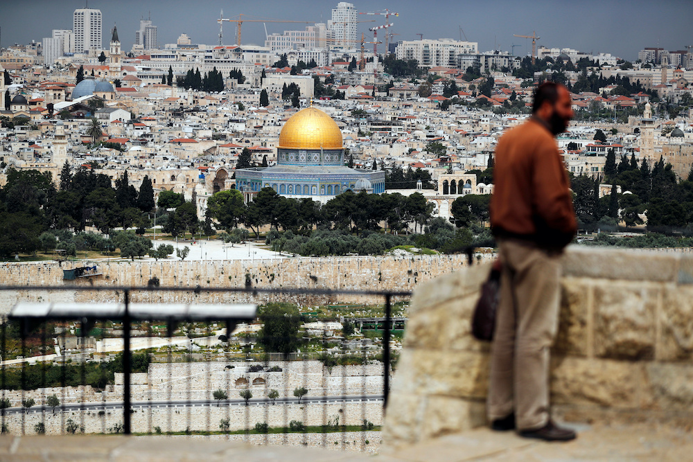 A man stands at a lookout site overlooking Jerusalem’s Old City as Muslims mark the first Friday prayer of Ramadan amid the coronavirus disease restrictions April 24, 2020. — Reuters pic