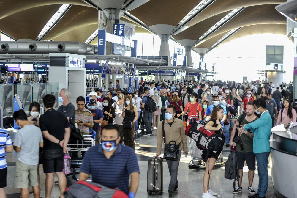 Travellers are pictured at the Kuala Lumpur International Airport in Sepang March 17, 2020. u00e2u20acu201d Picture by Shafwan Zaidon