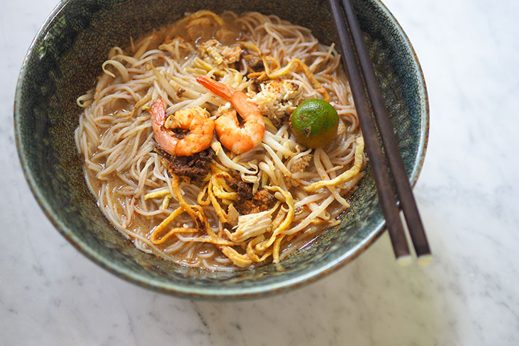 Drink up the delicious laksa that is served with 'sambal' and omelette strips