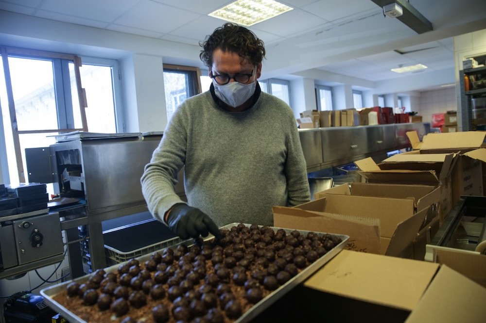 Brussels-based chocolate maker Laurent Gerbaud handles chocolates in his workshop in Brussels on April 9, 2020, during a lockdown in Belgium to curb the spread of the Covid-19 pandemic. — AFP pic