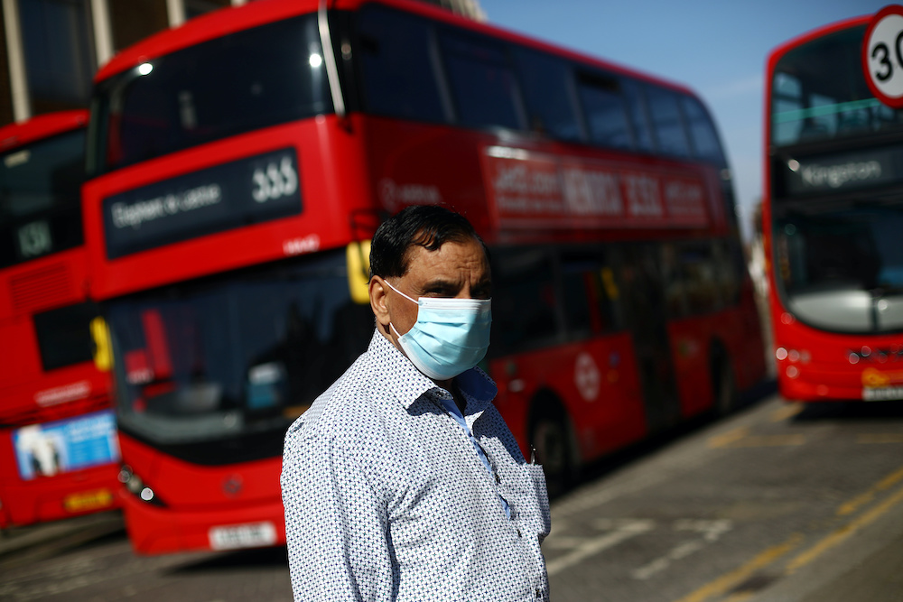 A man is seen wearing a protective face mask at a bus station as the spread of coronavirus disease (Covid-19) continues in London, Britain, April 15, 2020. u00e2u20acu2022 Reuters  picnn