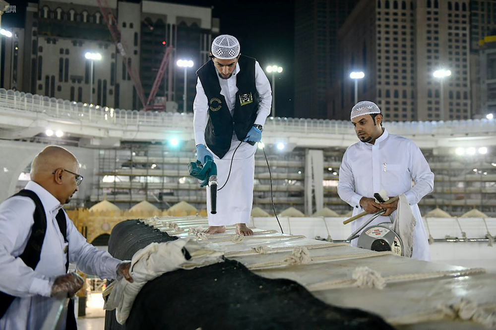 Workers clean and sterilise the roof of Kaaba, following the outbreak of the coronavirus disease, ahead of the holy fasting month of Ramadan, in the Grand mosque in the holy city of Mecca, Saudi Arabia April 21, 2020. u00e2u20acu201d Reuters picnn
