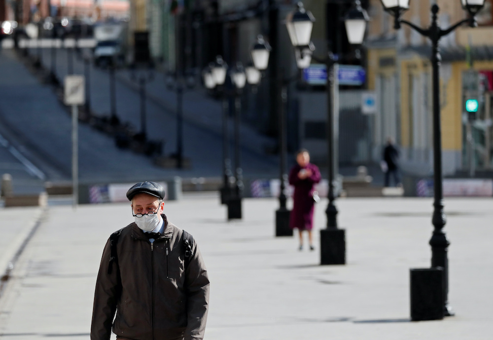 A man wearing a protective face mask walks along the street, as the spread of the coronavirus disease (Covid-19) continues, in Moscow, Russia April 10, 2020. u00e2u20acu201d Reuters picnn