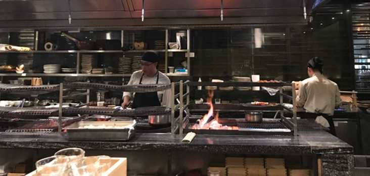 Open kitchen where chefs cook over charcoal grills or 'robata' style.