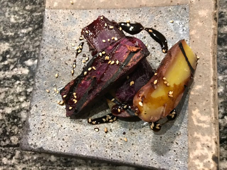 Kumara (sweet potatoes), with a sticky glaze and sesame seeds.
