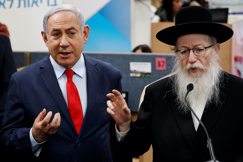 Israeli Prime Minister Benjamin Netanyahu and Health Minister Yaakov Litzman gesture as they deliver statements during a visit to the Health Ministry national hotline, in Kiryat Malachi, Israel March 1, 2020. u00e2u20acu201d Reuters picnnnn