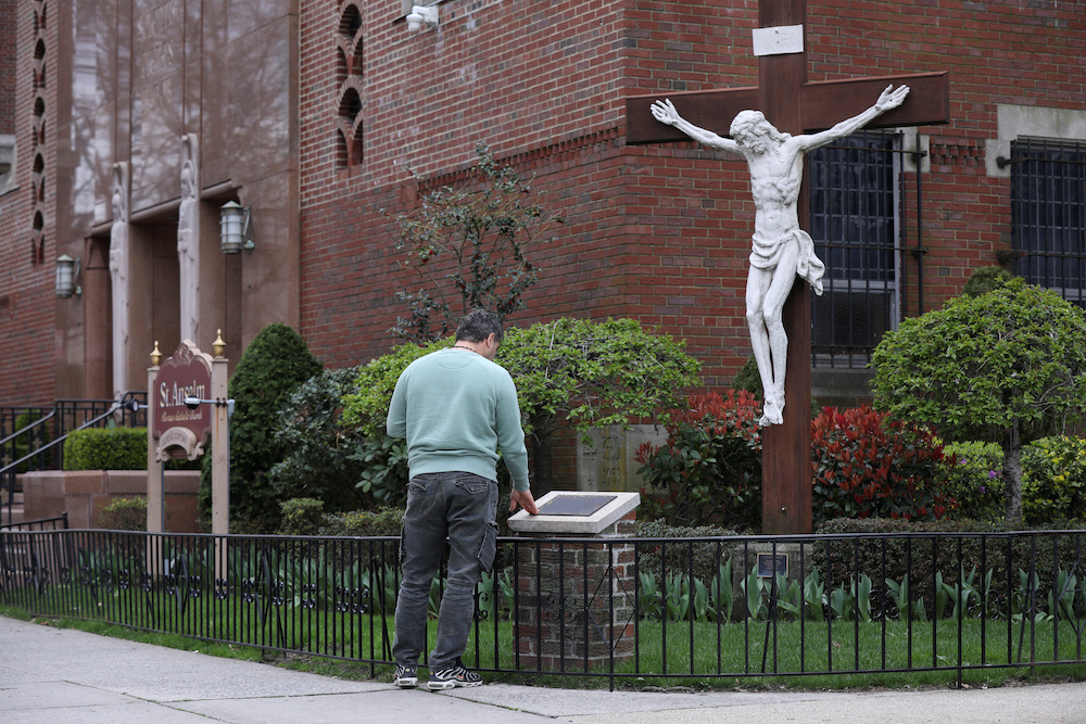 A man prays outside the closed Saint Anselm Church during the outbreak of coronavirus disease (Covid-19) in the Brooklyn borough of New York, US, April 10, 2020. u00e2u20acu2022 Reuters pic