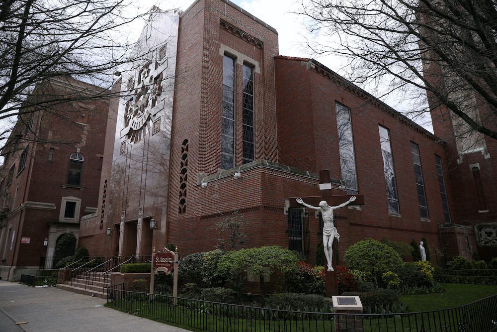 A man prays outside the closed Saint Anselm Church during the outbreak of coronavirus disease (Covid-19) in the Brooklyn borough of New York, US, April 10, 2020. ― Reuters pic