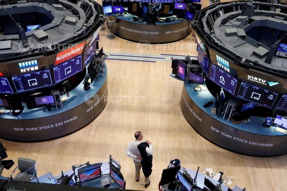 A trader puts on his jacket on the floor of the New York Stock Exchange as the building prepares to close indefinitely due to the coronavirus disease (Covid-19) outbreak in New York, US, March 20, 2020. u00e2u20acu201d Reuters picnn