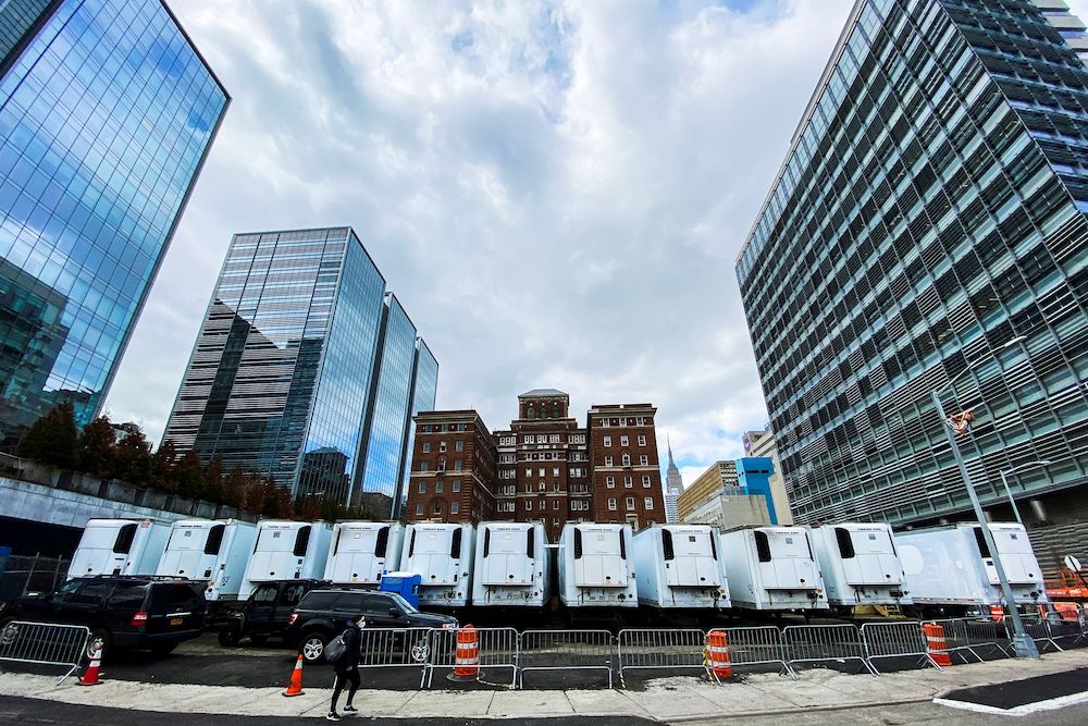 A woman walks near a row of refrigeration units used as makeshift morgues located behind Bellevue Hospital during the outbreak of the coronavirus disease (Covid-19) in New York City, US, March 31, 2020. — Reuters pic