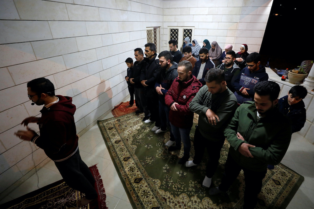 Palestinian worshippers perform the Taraweeh prayers in a house during the holy fasting month of Ramadan in Hebron in the Israeli-occupied West Bank April 27, 2020. u00e2u20acu201d Reuters picn