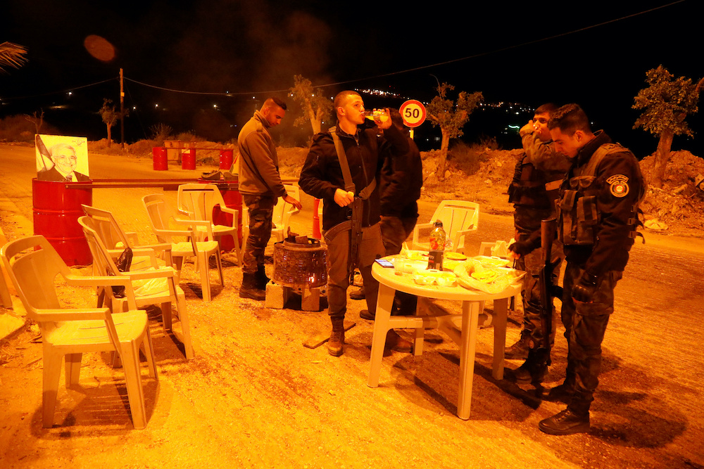 Members of Palestinian security forces have the pre-dawn meal before they start their long-day fast, during the holy month of Ramadan, in Nablus, in the Israeli occupied West Bank April 28, 2020. — Reuters pic