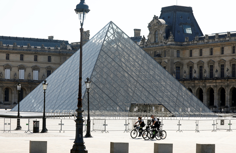 Policemen rides past the closed Louvre Pyramid designed by Chinese-born US architect Ieoh Ming Pei as a lockdown is imposed to slow the rate of the coronavirus disease in Paris, France, April 16, 2020. — Reuters pic