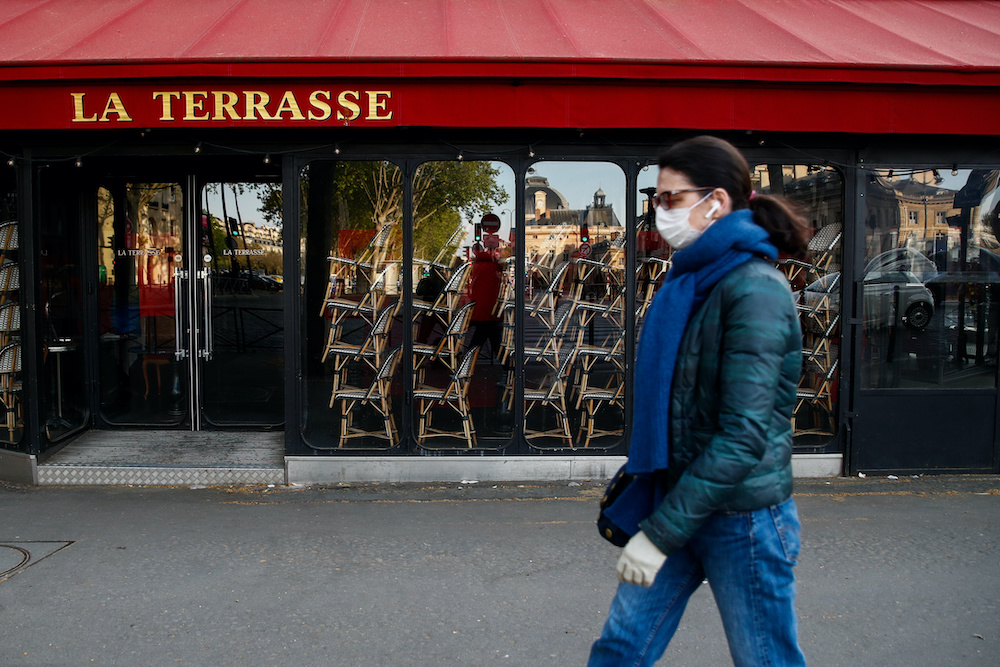 A woman wearing a protective face mask walks past a closed restaurant in Paris as a lockdown is imposed to slow the rate of the coronavirus disease in France, April 16, 2020. u00e2u20acu201d Reuters pic
