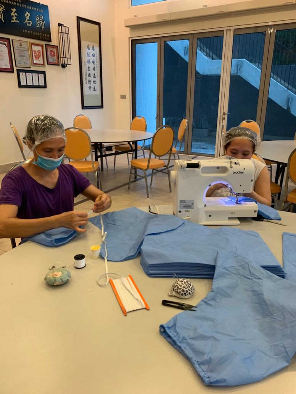 Designer Celest Thoi and a seamstress designing a PPE gown. — Picture by Melinda Looi