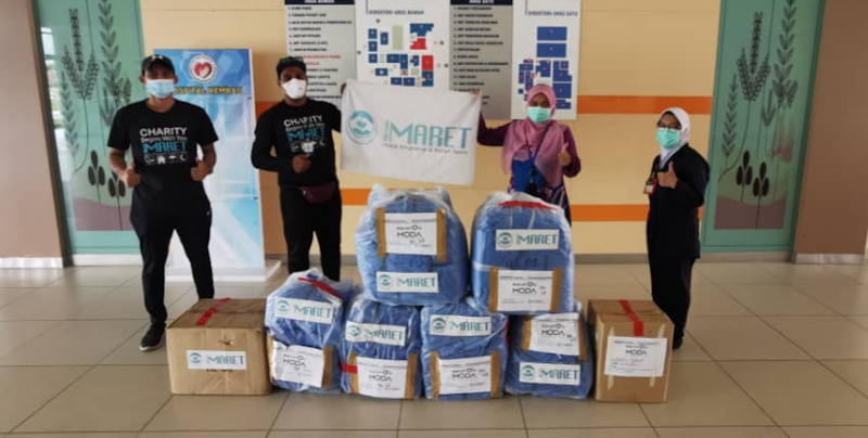 Imaret volunteers distributing PPE gowns to health clinics, hospitals. — Picture courtesy of Dr Husna Musa
