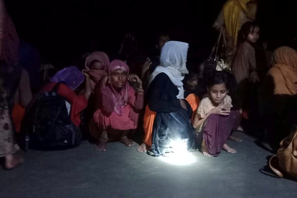 Rohingya refugees who were rescued by Bangladesh Coast Guard, sit on the shore in Teknaf, subdistrict of Coxu00e2u20acu2122s Bazar, Bangladesh April 15, 2020. Picture taken April 15, 2020. u00e2u20acu201d Reuters picnn