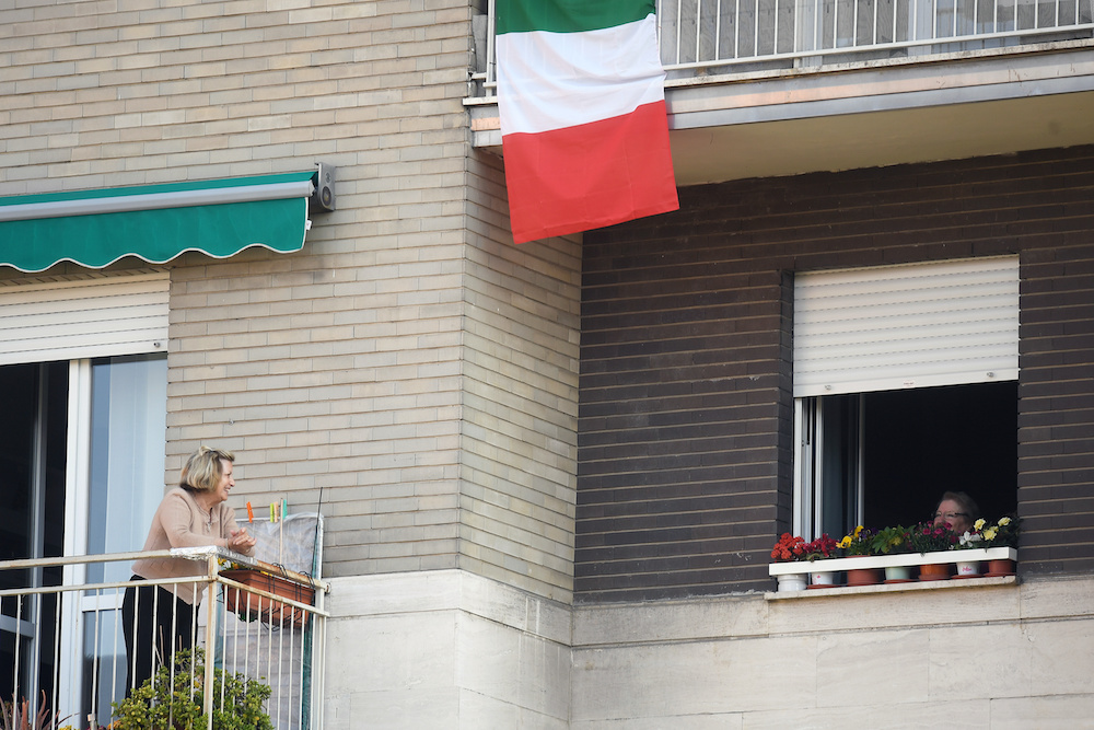 People talk from their balconies, amid the coronavirus disease (Covid19) outbreak in Milan, Italy April 9, 2020. — Reuters pic