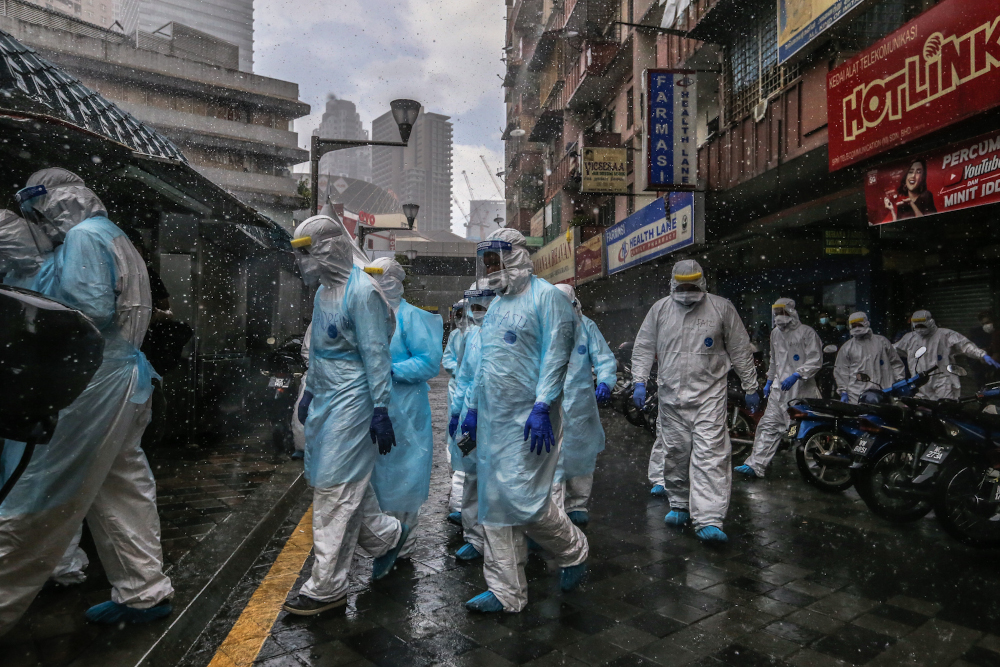 Health workers in protective suits are seen at Selangor Mansion in Jalan Masjid India April 6, 2020. u00e2u20acu201dPicture by Firdaus Latif